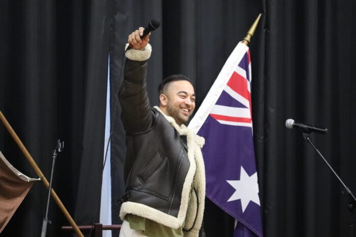 chris sebastian points mic to audience