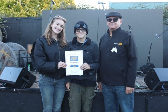 Busking Fire Opal receive their prize money 1 2